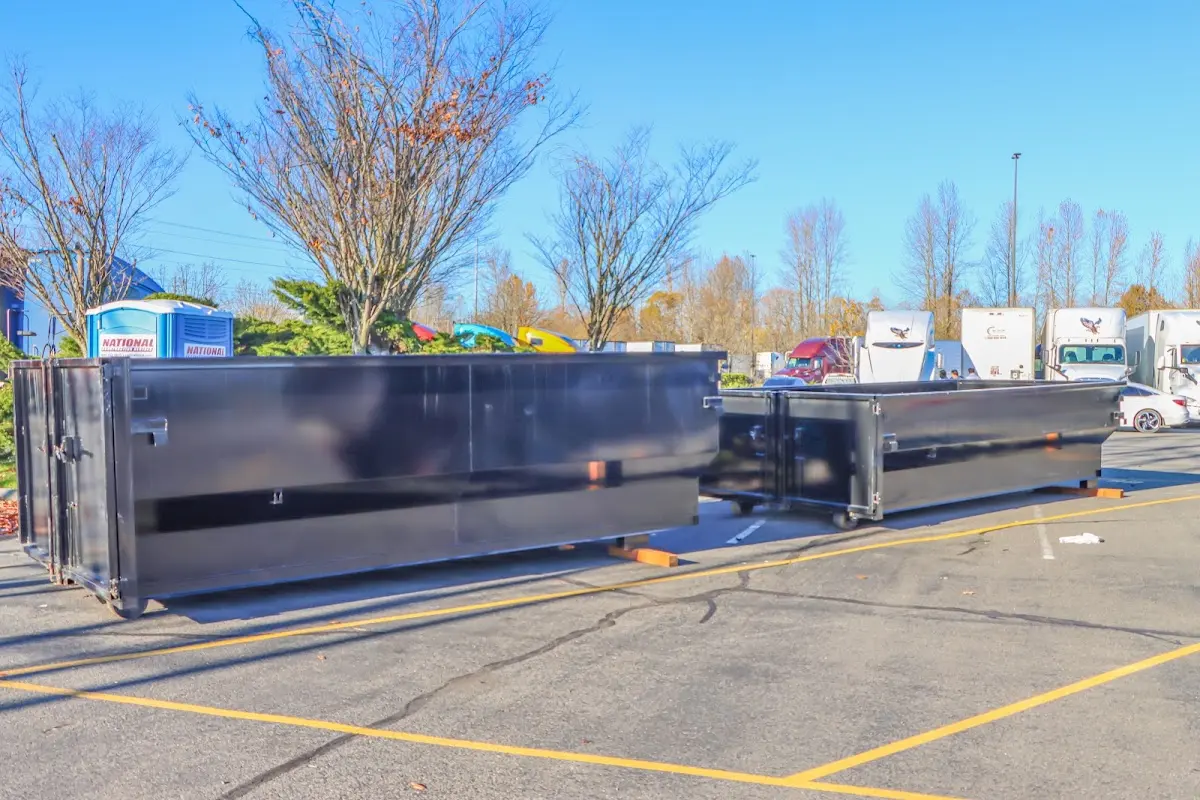 Professional dumpster rental service with roll-off container on residential driveway in South Huntingdon